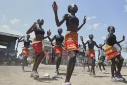 Fusion between culture and modernity as children dance in Kenyan refugee camp